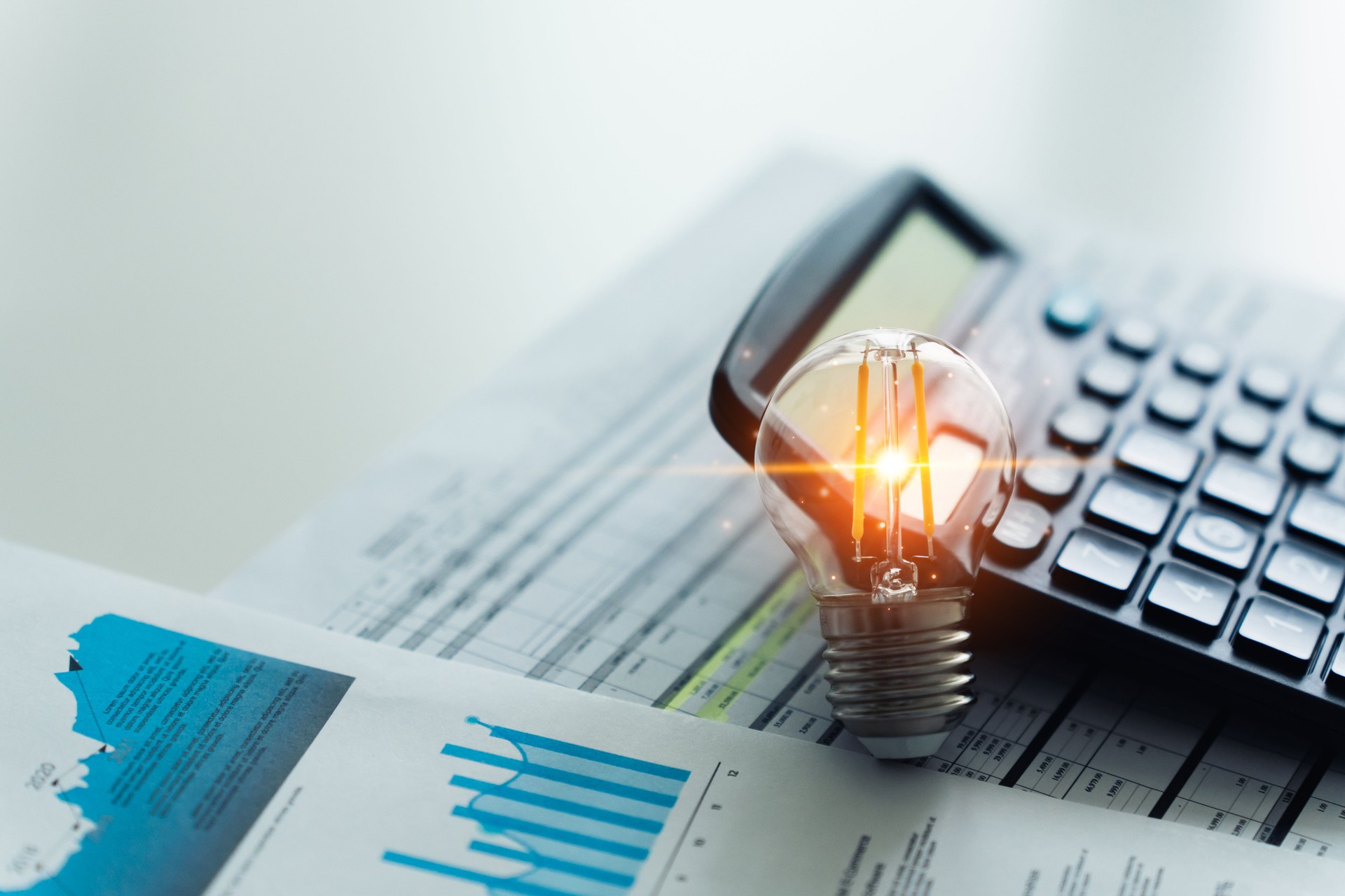Bright Business Idea and Financial Planning Concept with Calculator And Light Bulb